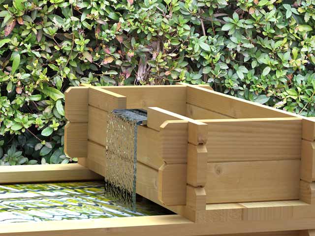 Could this sit directly adjacent to the raised bed pond on a wall of equal height, rather than directly over the raised bed pond?
